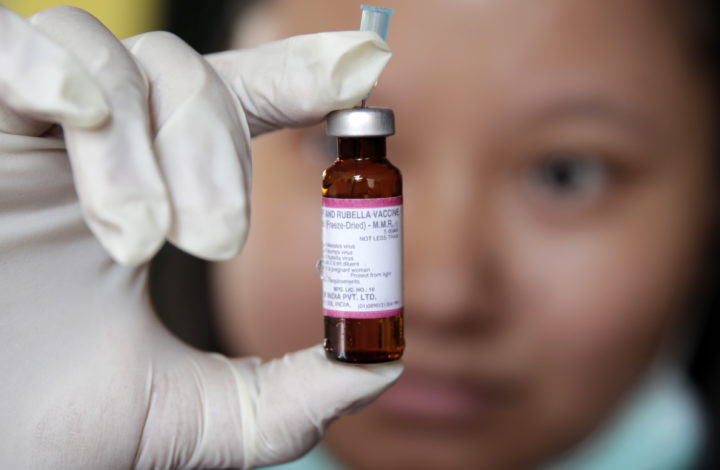 epa07373896 A Philippine Red Cross (PRC) health worker shakes a measles vaccine during a nationwide response program to immunization people at a slum area in Manila, Philippines, 16 February 2019. According to reports, an intensive vaccination program has been launched in Metro Manila and other affected areas to fight the measles outbreak. More than 70 people, mostly children under four-years of age, have been confirmed dead from the measles outbreak and over 4,300 people have fallen ill.  EPA/FRANCIS R. MALASIG