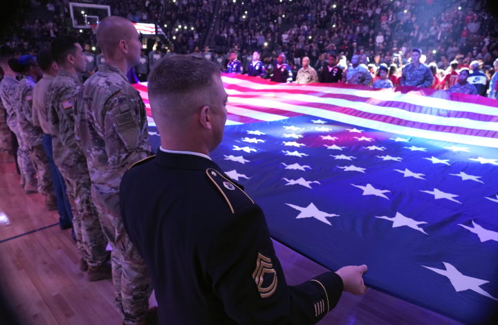 epa07161762 Members of the United States military stretch out the american flag during the national anthem and to honor Veterans Day at the NBA basketball game between the San Antonio Spurs and the Sacramento Kings at Golden 1 Center in Sacramento, California, USA, 12 November 2018.  EPA/JOHN G. MABANGLO  SHUTTERSTOCK OUT