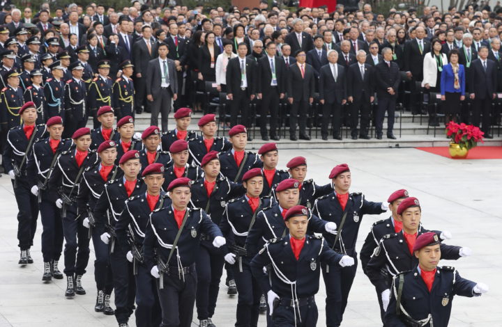epa08082675 Troops march during the flag-raising ceremony for Macao Special Administrative Region's (SAR) 20th anniversary at Lotus Flower Square in Macao, China, 20 December 2019. Macao had been a Portuguese colony until 1999 when it returned to Chinese rule under the 'one country, two systems' principle.  EPA/JOAO RELVAS