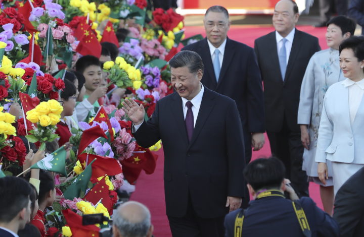 epa08078856 Chinese President Xi Jinping (C) is welcomed by children after his arrival at Macao International Airport in Macao, China, 18 December 2019. Xi is in Macao to participate in the Macao Special Administrative Region of the People's Republic of China's 20th anniversary celebrations. Macao was governed by Portugal until 1999 when it was transferred to China. As a special administrative region, Macao maintains separate governing and economic systems from that of mainland China.  EPA/JOAO RELVAS